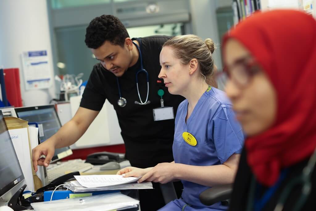 Trainer reviewing file with two trainees